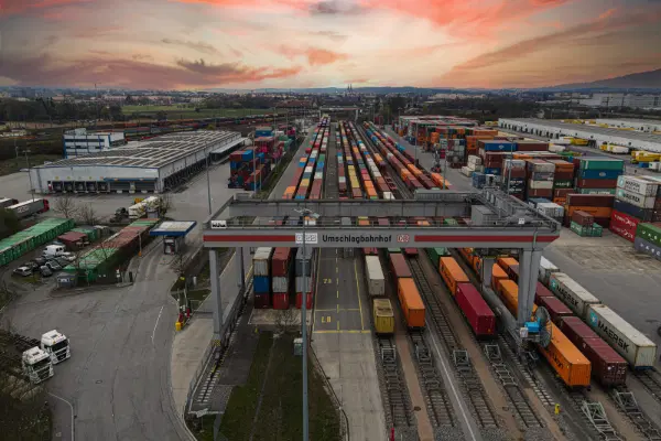 Railroad with train cars, loaded and prepared to transport containers.